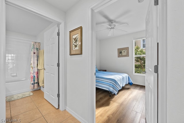 tiled bedroom with ceiling fan