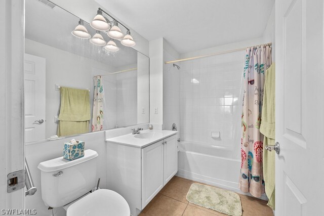 full bathroom with tile floors, toilet, shower / tub combo with curtain, and oversized vanity