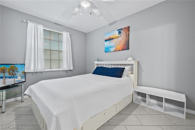 bedroom with light tile patterned floors and ceiling fan