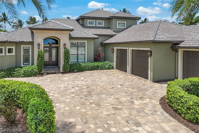 view of front of property with french doors and a garage