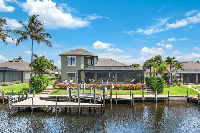 back of house with a lanai and a water view