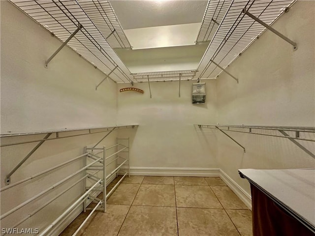 spacious closet featuring light tile patterned floors