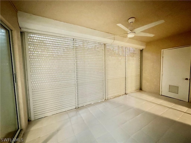 interior space with ceiling fan and visible vents