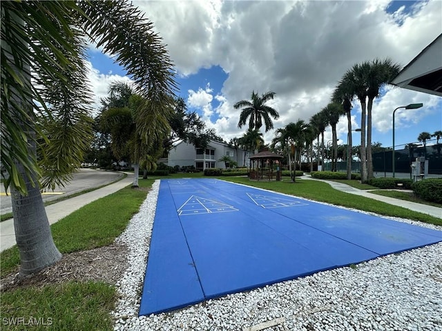 view of pool featuring shuffleboard, a gazebo, and a lawn