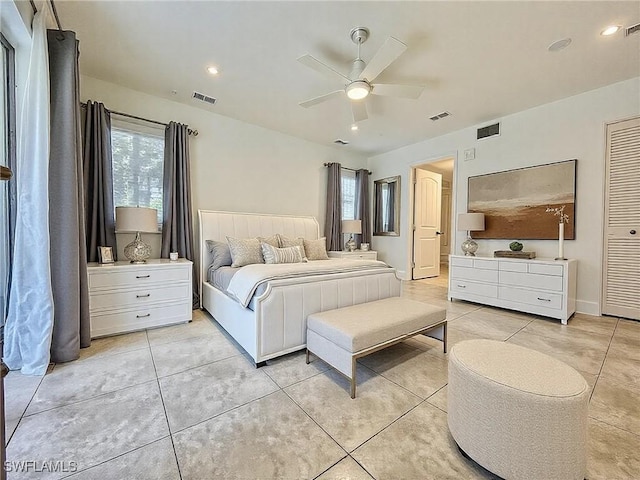 bedroom with light tile patterned floors, ceiling fan, and visible vents