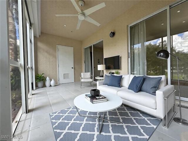 sunroom featuring ceiling fan