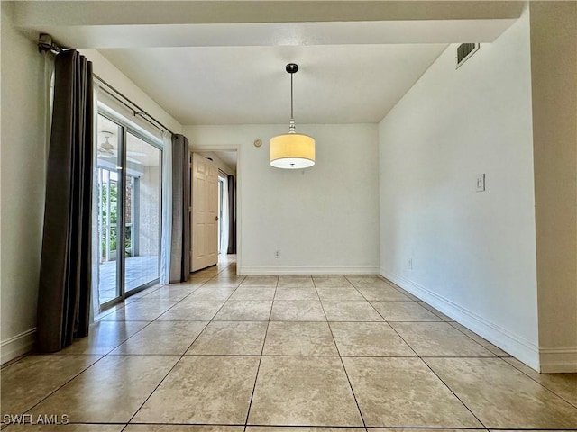 unfurnished dining area featuring light tile patterned floors, visible vents, and baseboards