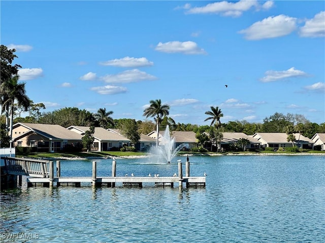 view of dock featuring a water view and a residential view