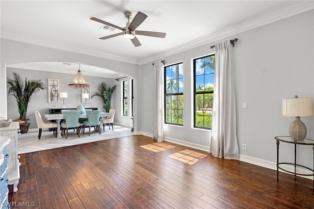 dining room featuring dark hardwood / wood-style flooring, ceiling fan with notable chandelier, and ornamental molding