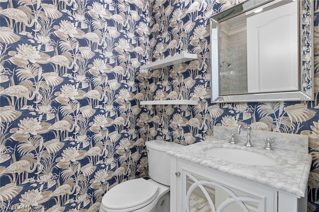 bathroom featuring vanity and toilet