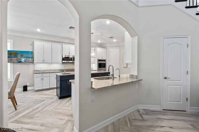 kitchen featuring stainless steel appliances, sink, light parquet floors, and white cabinets