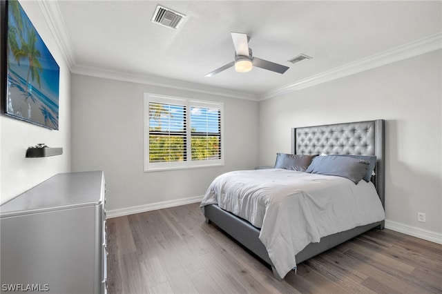 bedroom with crown molding, ceiling fan, and hardwood / wood-style floors