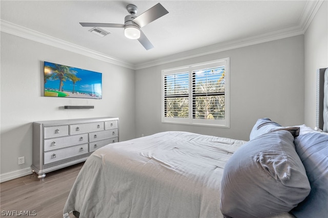 bedroom with crown molding, ceiling fan, and hardwood / wood-style floors