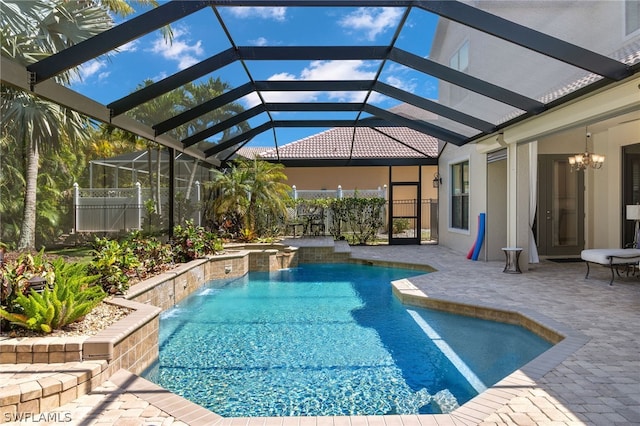 view of pool with pool water feature, a hot tub, a patio area, and glass enclosure