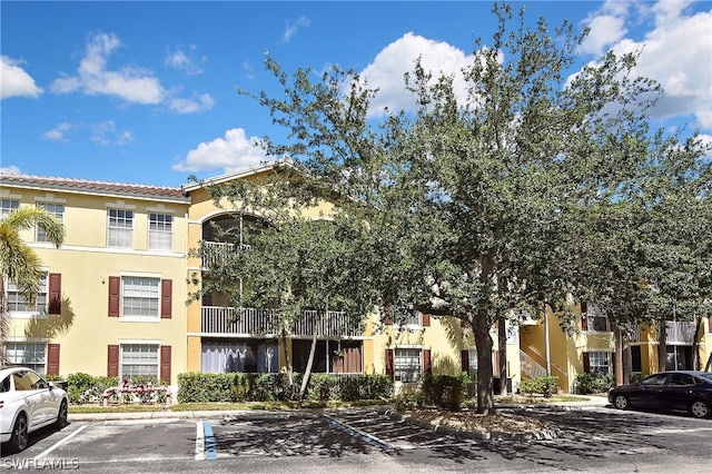 view of property featuring uncovered parking