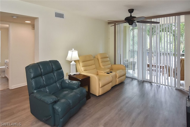 living room featuring hardwood / wood-style floors and ceiling fan