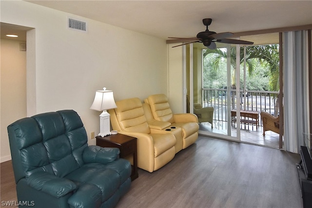 sitting room with ceiling fan, plenty of natural light, and hardwood / wood-style flooring