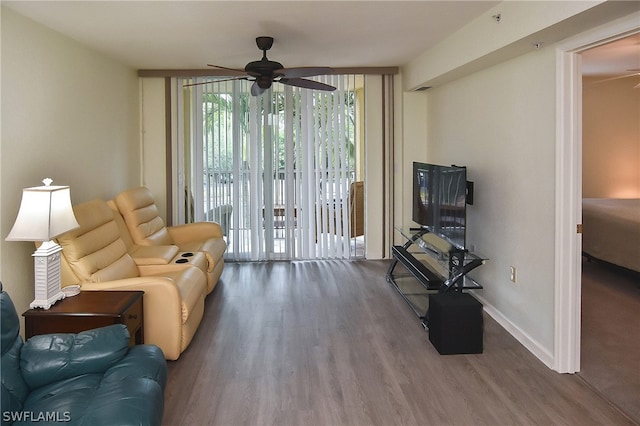 living room with hardwood / wood-style floors and ceiling fan