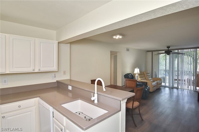 kitchen featuring kitchen peninsula, white cabinetry, dishwasher, and sink