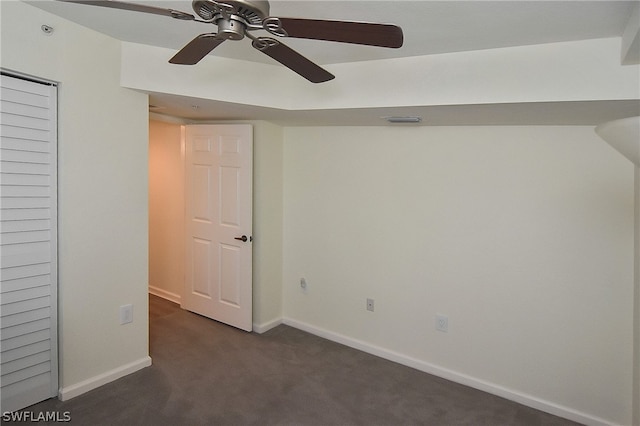 interior space featuring ceiling fan and dark colored carpet