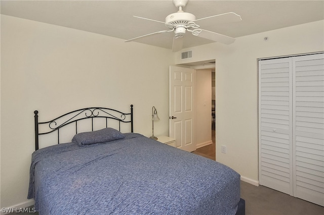 bedroom with a closet, dark carpet, and ceiling fan