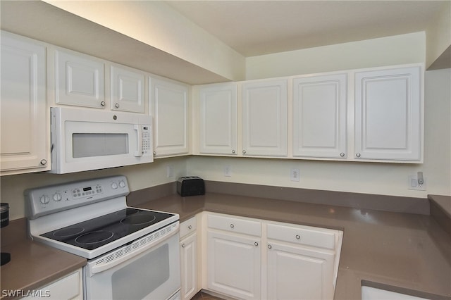 kitchen featuring white appliances and white cabinetry