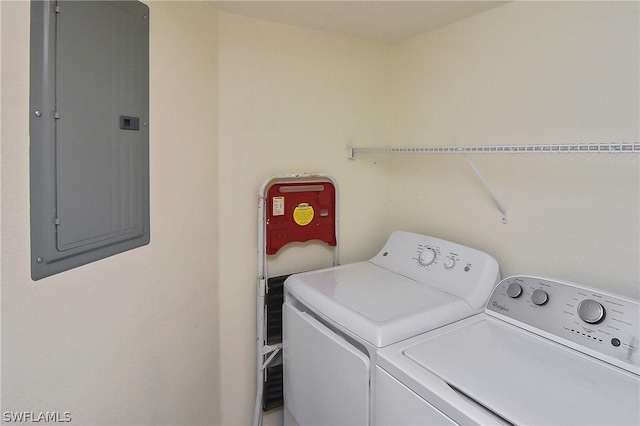 laundry area featuring washing machine and clothes dryer and electric panel