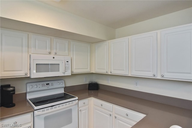 kitchen with white cabinetry and white appliances