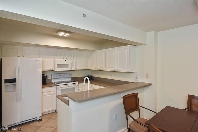 kitchen featuring kitchen peninsula, light tile patterned floors, white appliances, and white cabinetry