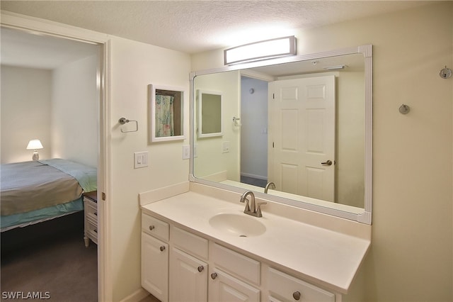 bathroom featuring a textured ceiling and vanity