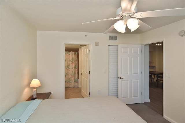 bedroom with ensuite bath and ceiling fan