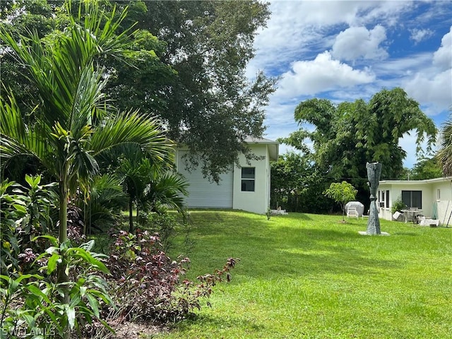 view of green lawn with an outbuilding