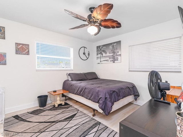 bedroom with ceiling fan and light hardwood / wood-style floors