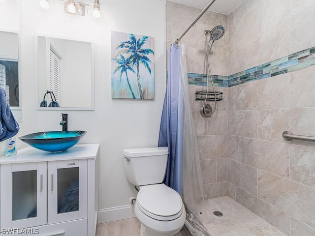 bathroom featuring walk in shower, vanity, toilet, and hardwood / wood-style flooring