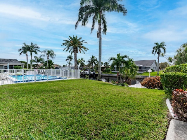 view of yard with a water view and a community pool