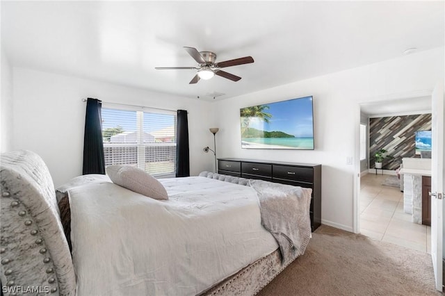 bedroom featuring ceiling fan, light tile patterned floors, and wood walls