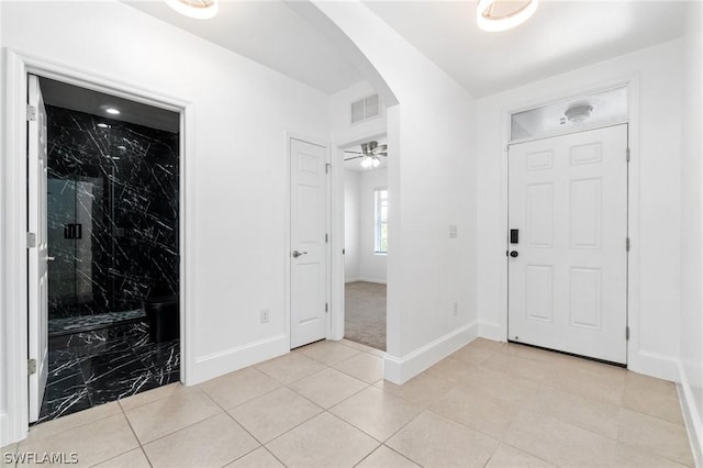 entrance foyer featuring ceiling fan and light tile patterned flooring