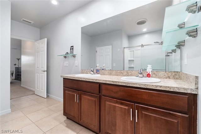 bathroom with tile patterned flooring, vanity, and a shower with shower door