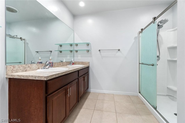 bathroom featuring tile patterned flooring, vanity, and a shower with shower door