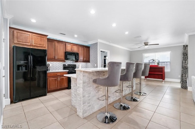 kitchen featuring light tile patterned floors, ceiling fan, ornamental molding, and black appliances