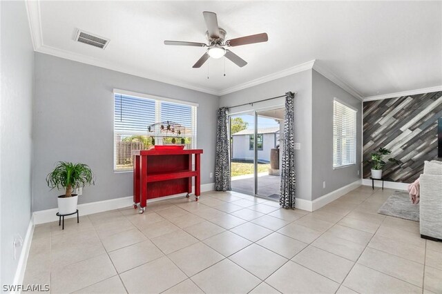 foyer featuring ceiling fan, wood walls, light tile patterned floors, and crown molding