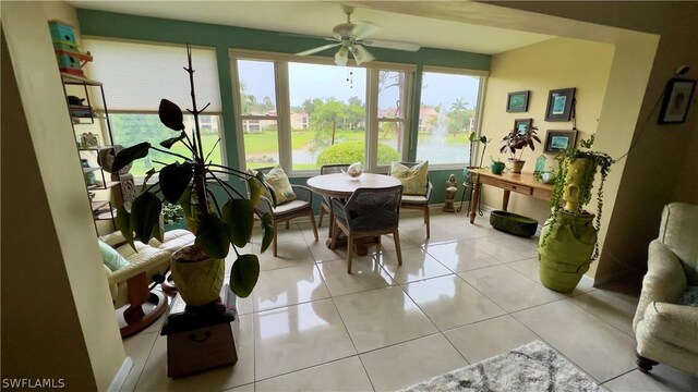 sunroom / solarium featuring ceiling fan