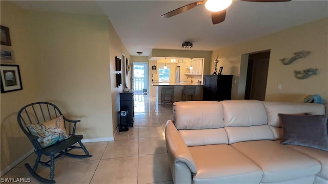 living room with light tile patterned flooring and ceiling fan