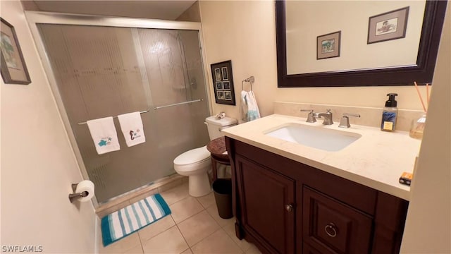 bathroom featuring tile patterned floors, toilet, an enclosed shower, and vanity