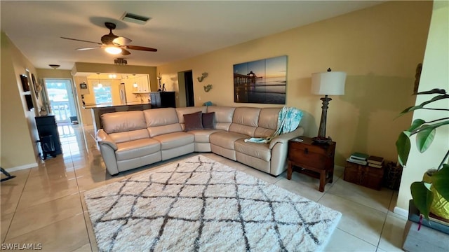 living room featuring light tile patterned floors and ceiling fan