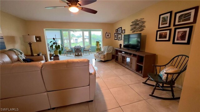 living room with light tile patterned floors and ceiling fan