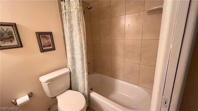 bathroom with shower / tub combo with curtain and toilet