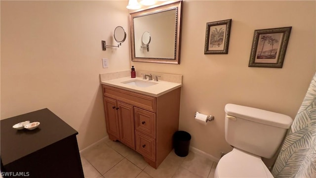 bathroom featuring tile patterned floors, vanity, and toilet