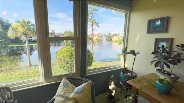 sunroom / solarium with plenty of natural light and a water view