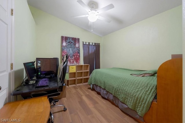 bedroom featuring ceiling fan, lofted ceiling, and light hardwood / wood-style floors